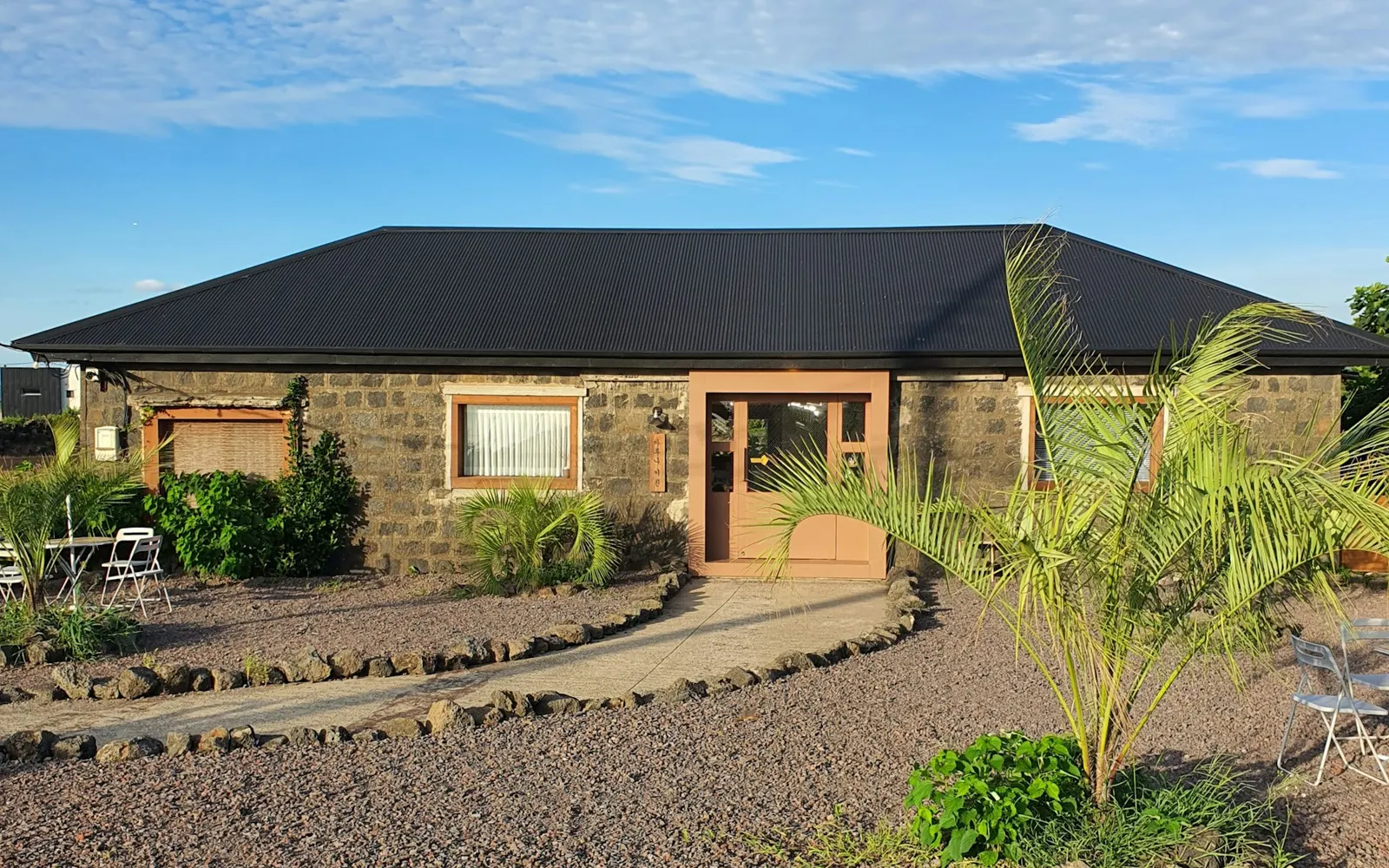 House with a gravel driveway leading to the front entrance.